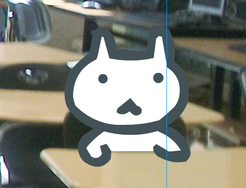 A white cat behind a desk